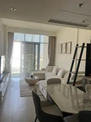 a living room with a white couch and a table at Burj Khalifa View Ideal for Families in Dubai