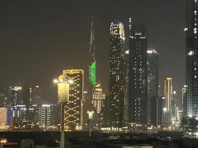 a nighttime view of a large city at night at Burj Khalifa View Ideal for Families in Dubai
