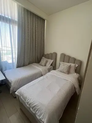 two beds in a room with a window at Burj Khalifa View Ideal for Families in Dubai