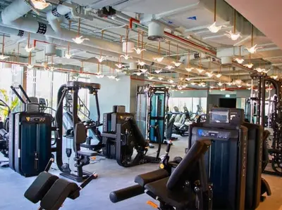 a gym with several treadmills and exercise bikes at Vogue Downtown Mag 318 near Burj Khalifa and Dubai Mall, Studio Apartment with Balcony, Canal and City Skyline View, Access to all Amenities in Dubai