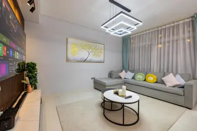 a living room with a couch and a table at 3-Bedroom Cozy Townhouse with great amenities in Dubai in Dubai