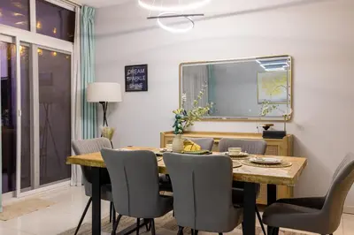 a dining room with a table and chairs at 3-Bedroom Cozy Townhouse with great amenities in Dubai in Dubai