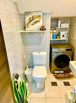 a bathroom with a toilet and a washing machine at 3-Bedroom Cozy Townhouse with great amenities in Dubai in Dubai