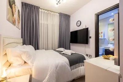 a bedroom with a bed and a tv in it at 3-Bedroom Cozy Townhouse with great amenities in Dubai in Dubai