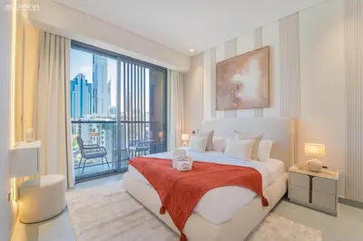 a bedroom with a large bed and a large window at Near Museum of the Future - Homey Apartment-Jumeirah Garden in Dubai