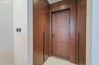 a wooden door in a room with a wall at Near Museum of the Future - Homey Apartment-Jumeirah Garden in Dubai