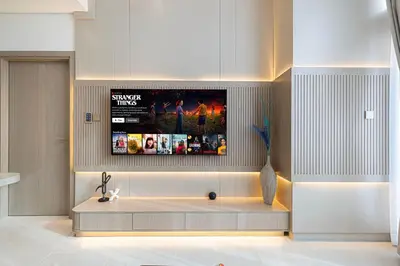 a living room with a tv on the wall at Luxury Binghatti Phantom Suites By Hostiva in Dubai