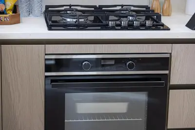 a black stove top oven in a kitchen at Luxury Binghatti Phantom Suites By Hostiva in Dubai