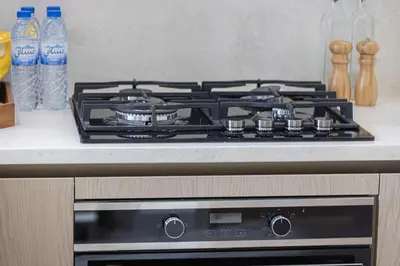 a stove top oven sitting on top of a kitchen counter at Luxury Binghatti Phantom Suites By Hostiva in Dubai