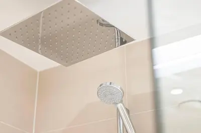 a shower in a bathroom with a shower head at Coastal Hideaway in La Mer - Beach Access and Burj View in Dubai