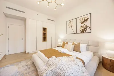 a bedroom with a large bed and a couch at Coastal Hideaway in La Mer - Beach Access and Burj View in Dubai