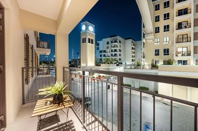 a balcony with a clock tower in the background at Coastal Hideaway in La Mer - Beach Access and Burj View in Dubai