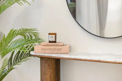 a box of minimalism sitting on a table in front of a mirror at Coastal Hideaway in La Mer - Beach Access and Burj View in Dubai