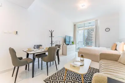 a living room with a couch and a table at Charming Studio, Easy Access to Beach - Botanica Tower, Dubai Marina by Deluxe Holiday Homes in Dubai