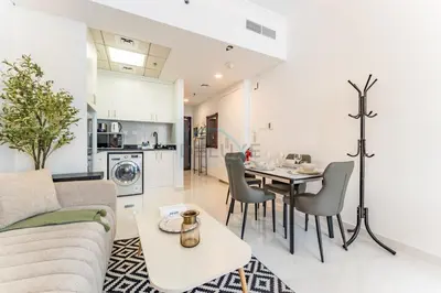 a living room and kitchen with a table and chairs at Charming Studio, Easy Access to Beach - Botanica Tower, Dubai Marina by Deluxe Holiday Homes in Dubai