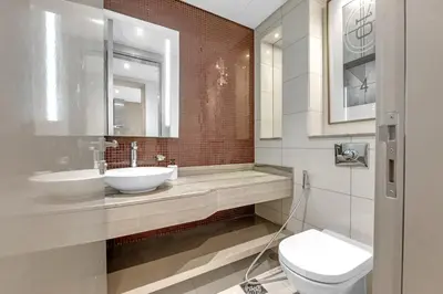 a bathroom with two sinks and a toilet at Burj Khalifa View - Luxurious 1BHK in Business Bay in Dubai