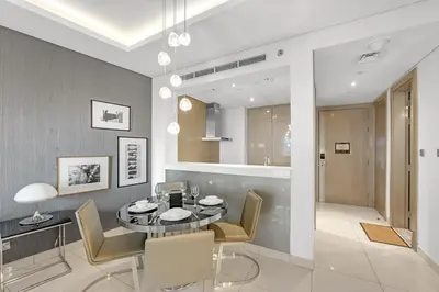 a dining room with a table and chairs and a bathroom at Burj Khalifa View - Luxurious 1BHK in Business Bay in Dubai
