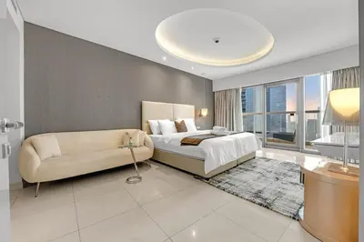 a bedroom with a large bed and a couch at Burj Khalifa View - Luxurious 1BHK in Business Bay in Dubai
