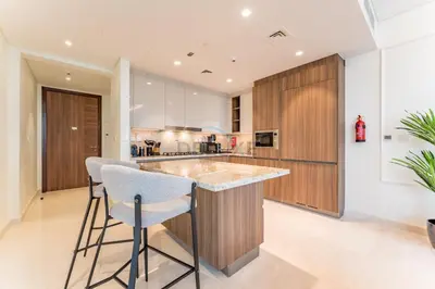 a kitchen with a large island with bar stools at Burj Khalifa View, Easy Access to Dubai Mall and Burj Khalifa - Imperial Avenue, Downtown Dubai by Deluxe Holiday Homes in Dubai