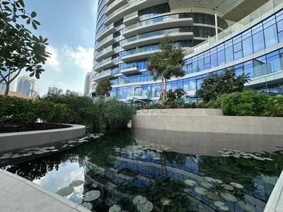 a building with a pond in front of a building at Burj Khalifa View, Easy Access to Dubai Mall and Burj Khalifa - Imperial Avenue, Downtown Dubai by Deluxe Holiday Homes in Dubai