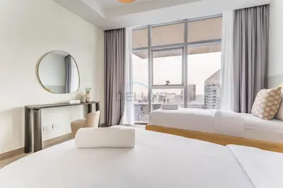 a hotel room with two beds and a large window at Burj Khalifa View, Easy Access to Dubai Mall and Burj Khalifa - Imperial Avenue, Downtown Dubai by Deluxe Holiday Homes in Dubai