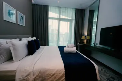 a bedroom with a large bed with a large window at Luxury Studio at PRIVE by DAMAC - Canal Views in Dubai