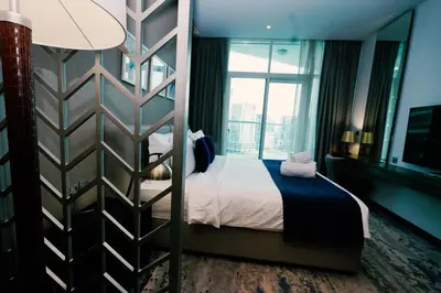 a hotel room with a bed and a window at Luxury Studio at PRIVE by DAMAC - Canal Views in Dubai