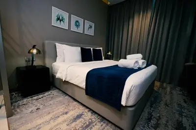 a bedroom with a large bed with towels on it at Luxury Studio at PRIVE by DAMAC - Canal Views in Dubai