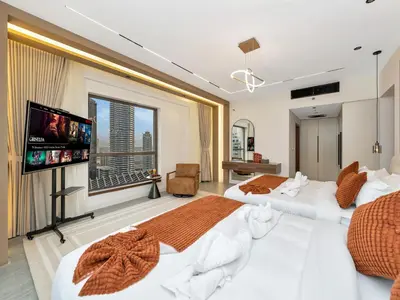 a bedroom with two beds and a flat screen tv at 4 BHK JBR BEACHFRONT# Next to Dubai Eye# Marina View in Dubai