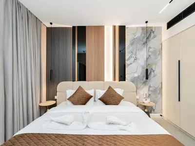 a bedroom with a large white bed with two towels at 4 BHK JBR BEACHFRONT# Next to Dubai Eye# Marina View in Dubai