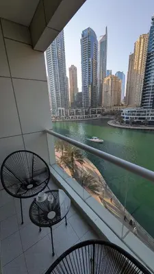 a balcony with two tables and a view of a city at Superb Marina Views, Entire 1BR Apartment - Atlantic Towers next to Marina Mall in Dubai