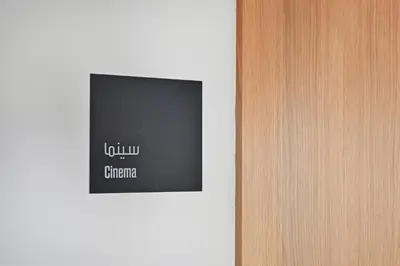 a flat screen tv on a white wall at Socio Tower Apt - Parking, Balcony&Pool - by Rentujemy in Dubai