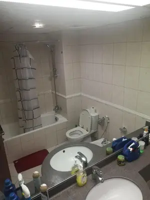 a bathroom with a sink and a toilet and a mirror at Spacious Master Bedroom with Balcony Horizon Tower, Dubai Marina in Dubai
