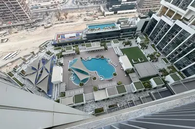 an aerial view of a pool on top of a building at Cosy Sobha Hartland Apt - Pool&Gym - Near Downtown in Dubai