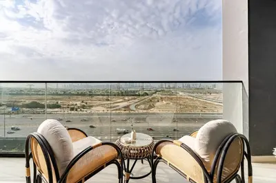 a room with a table and chairs and a large window at Cozy and Stylish 1BR in JVC in Dubai