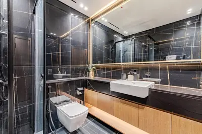 a bathroom with a white toilet and a sink at Cozy and Stylish 1BR in JVC in Dubai