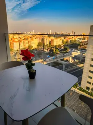 a white table with a red flower on top of it at Luxury Studio in Dubai in Dubai