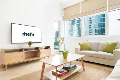 a living room with a couch and a tv at New 2BR in Dubai Marina - JBR & Marina View in Dubai