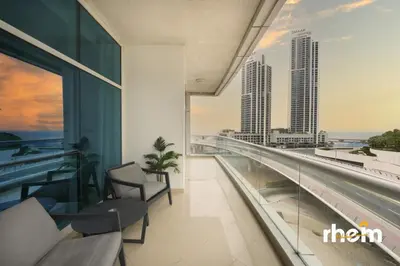 a room with a balcony with a view of a city at New 2BR in Dubai Marina - JBR & Marina View in Dubai