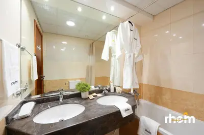 a bathroom with two sinks and a large mirror at New 2BR in Dubai Marina - JBR & Marina View in Dubai