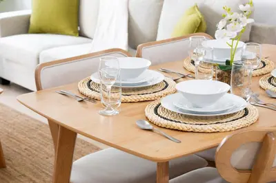 a dining room table with plates and bowls on it at New 2BR in Dubai Marina - JBR & Marina View in Dubai