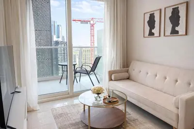 a living room with a couch and a large window at Canal View Retreat in Business Bay in Dubai