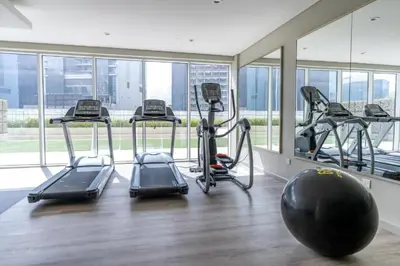 a gym with several treadmills and a large window at Canal View Retreat in Business Bay in Dubai