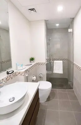 a bathroom with a sink and a toilet and a shower at Canal View Retreat in Business Bay in Dubai