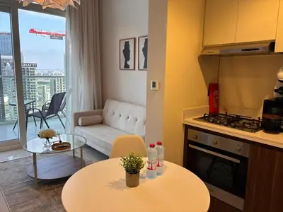 a kitchen and living room with a table and a couch at Canal View Retreat in Business Bay in Dubai
