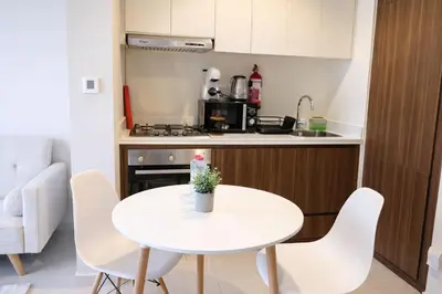 a small kitchen with a white table and chairs at Canal View Retreat in Business Bay in Dubai