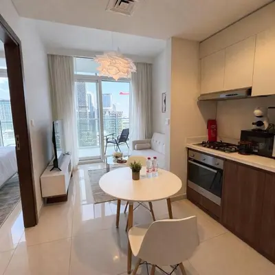 a kitchen and living room with a table and a dining room at Canal View Retreat in Business Bay in Dubai