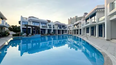 a swimming pool in the middle of a building at Palm Jumeirah Luxury Villa 4BR Private BeachAccess in Dubai