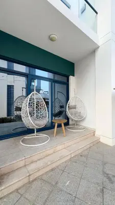 two chairs and a table in front of a building at Palm Jumeirah Luxury Villa 4BR Private BeachAccess in Dubai