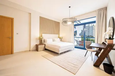 a bedroom with a bed and a desk and a window at Palm Jumeirah Luxury Villa 4BR Private BeachAccess in Dubai